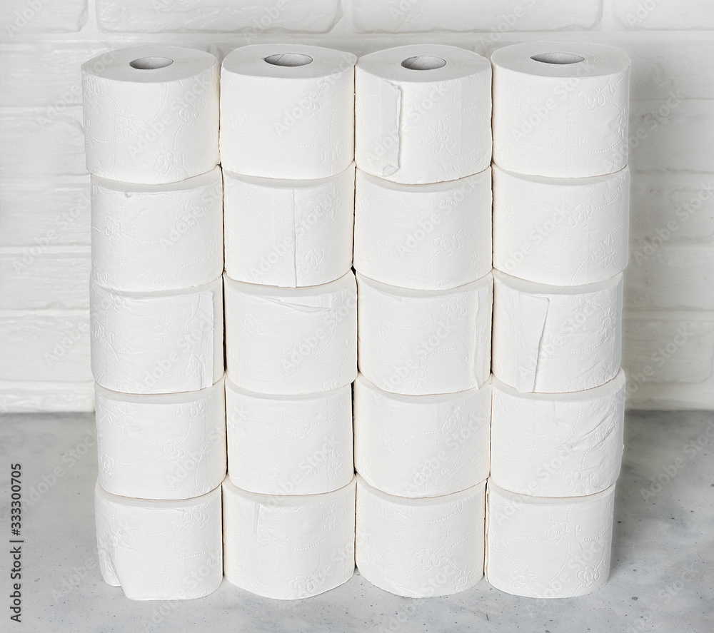 Toilet paper rools stacked on top of each other with brick wall Toilet paper rools stacked on top of each other with brick wall