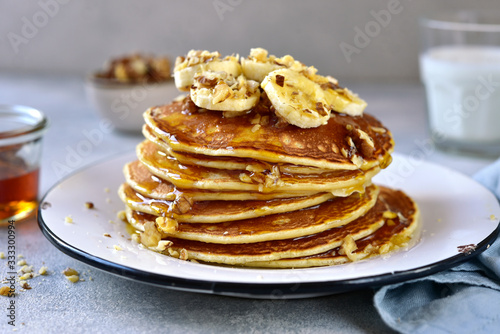 Homemade delicious banana pancakes with walnuts and maple syrup.