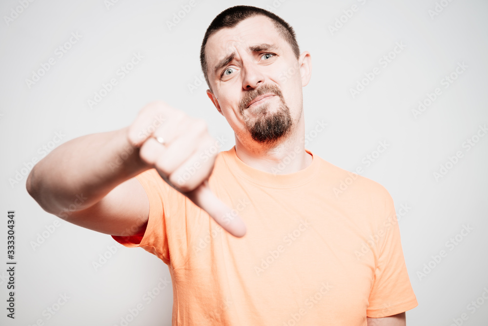 man showing a thumb down gesture man showing a thumb down gesture
