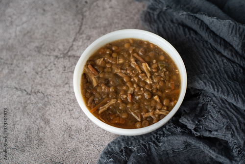 A bowl of lentil soup with chicken, Mediterranean soup with thick stew like broth. 