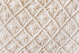 Close-up of hand made macrame texture pattern. ECO friendly modern knitting DIY natural decoration concept. Flat lay.