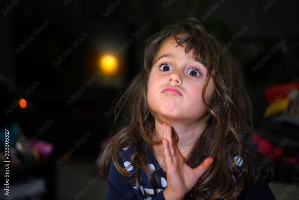 little girl with big eyes make funny faces, with copy space little girl with big eyes make funny faces, with copy space