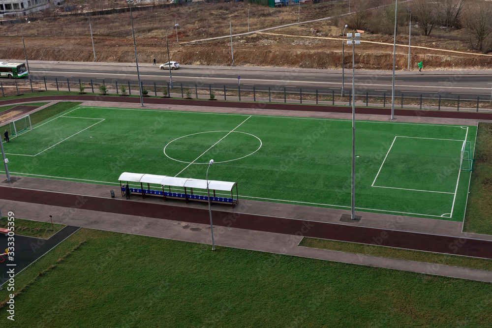 Fototapeta premium view from a height of a residential quarter of the city with a sports ground