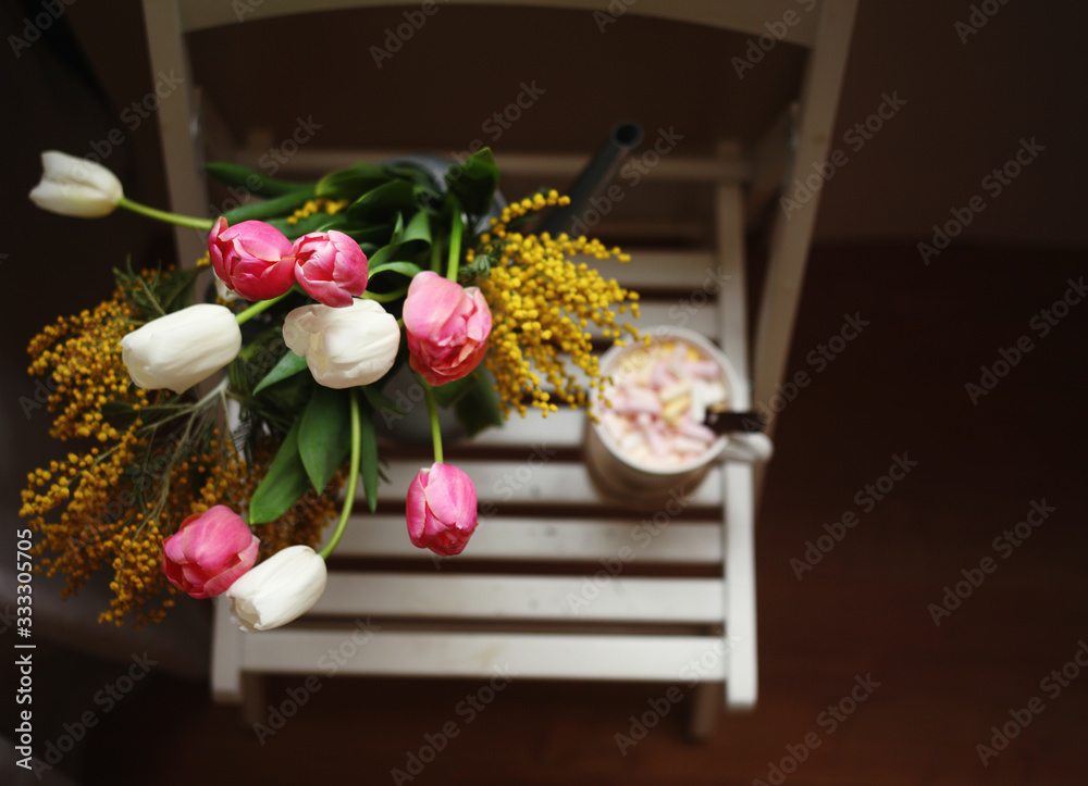 March 8,Easter,Mother's day concept /tulips in the vase,cup of coffee with marshmallows,open book ,glasses