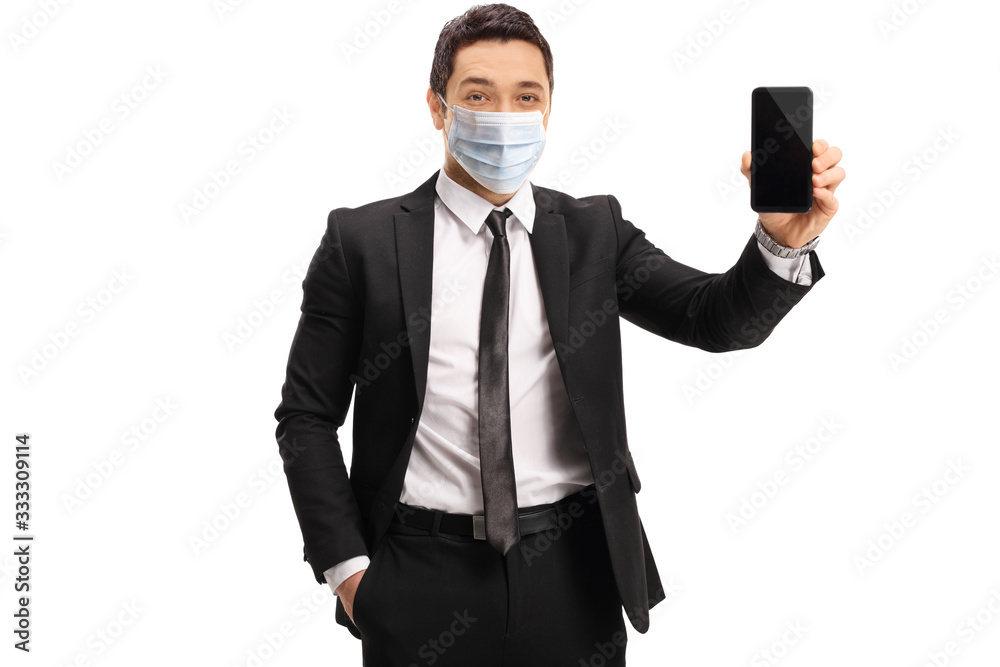 Businessman wearing a medical mask and showing a mobile phone Businessman wearing a medical mask and showing a mobile phone