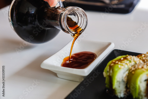 Bowl with tasty soy sauce. ...