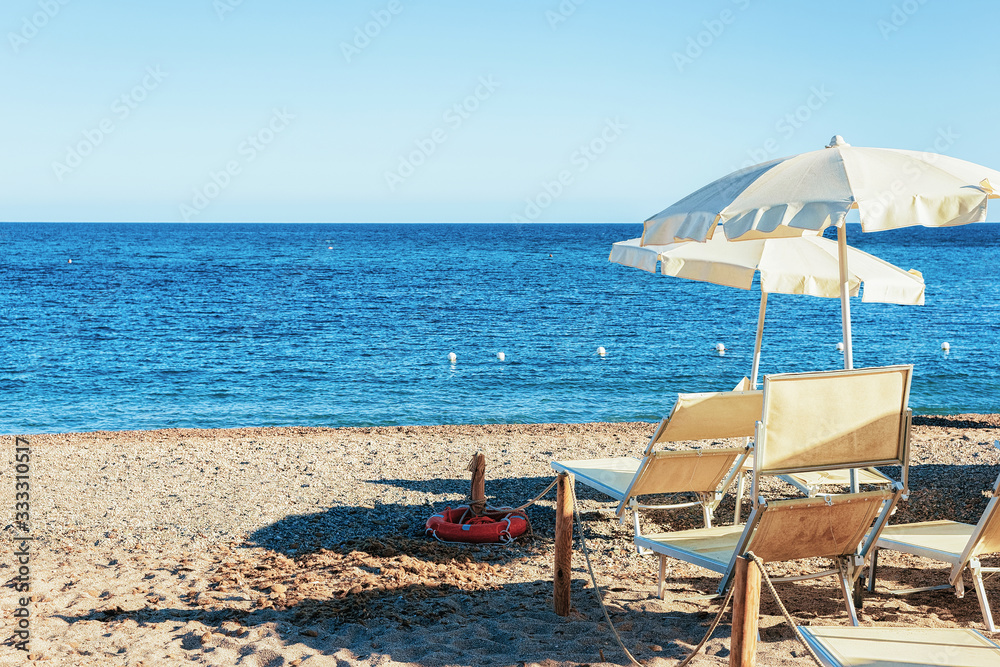 Umbrella and longue chair at Chia beach Mediterranean sea