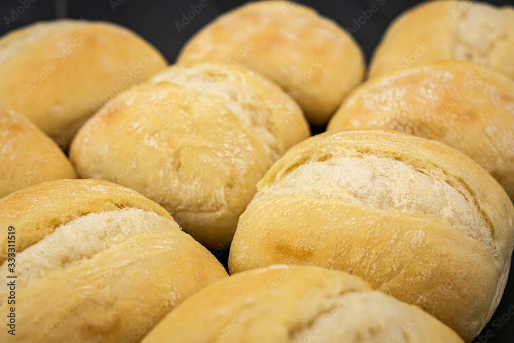 loaves of crispy golden bread, freshly made in a bakery