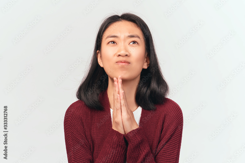 Dreamy, hopeful cute girl believe god, press palms together over chest, hope wish fulfill, looking up. Beautiful woman dressed in burgundy cardigan stands isolated white background Studio Dreamy, hopeful cute girl believe god, press palms together over chest, hope wish fulfill, looking up. Beautiful woman dressed in burgundy cardigan stands isolated white background Studio
