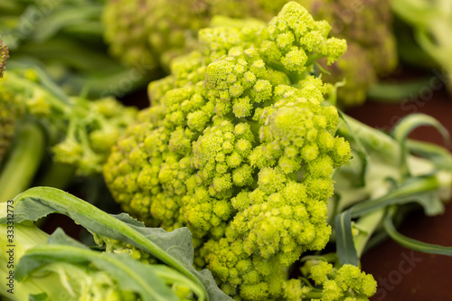 A closeup view of a head of Romanesco broccoli, on display at a local farmers market.