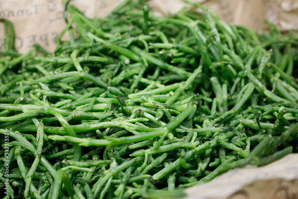 A closeup view of a basket of sea beans, on display at a local grocery store. A closeup view of a basket of sea beans, on display at a local grocery store.
