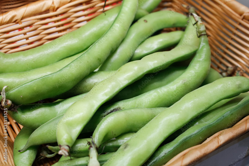 A closeup view of a basket full of fava beans, on display at a local farmers market. A closeup view of a basket full of fava beans, on display at a local farmers market.
