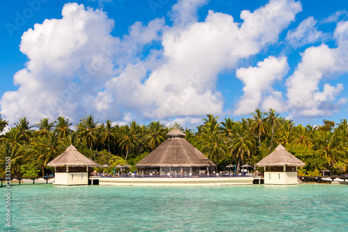 A view at the beach and waterhuts at tropical island, Maldives