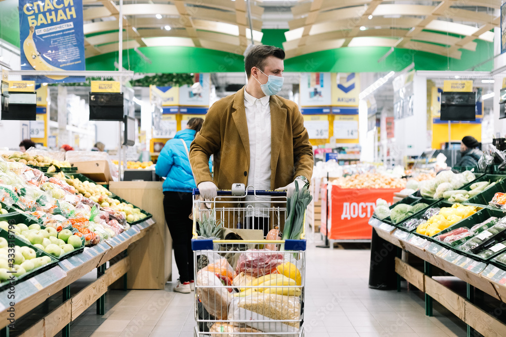 a man in a medical mask buys food at a grocery store. Coronavirus, virus, infection, epidemic, pandemic. RUSSIA, RUSSIA-MARCH 19, 2020. OBNINSK