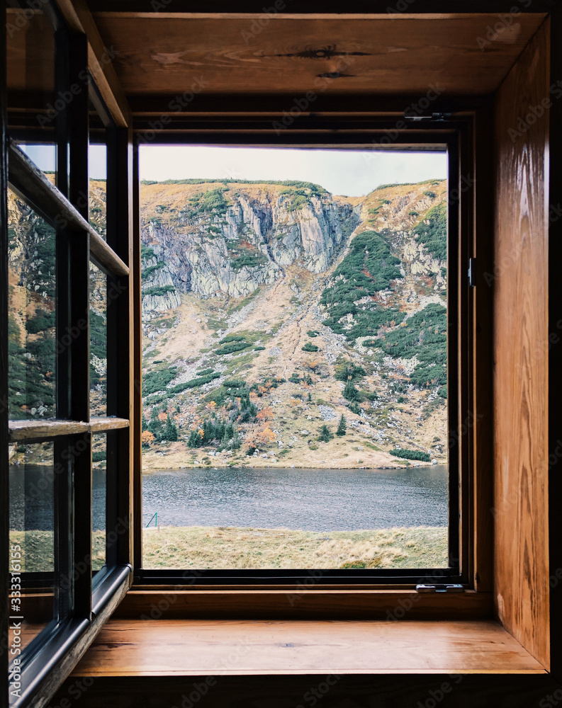 Mountain landscape outside window, details on windowsill. Outside view of bright mountains Mountain landscape outside window, details on windowsill. Outside view of bright mountains