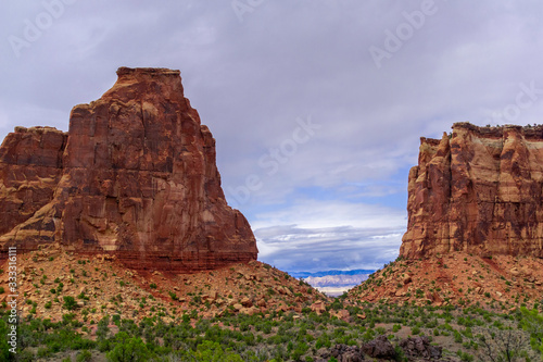 red rocks and blue sky with distant mountains