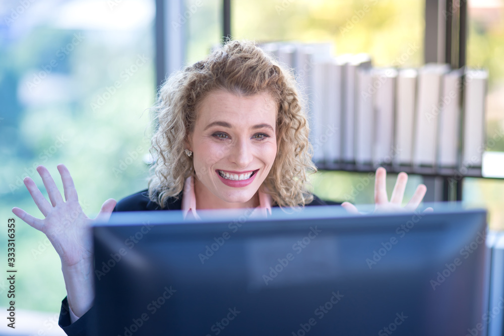 A business woman with curly blonde hair, raise hands, very happy, Concept, Working women and business A business woman with curly blonde hair, raise hands, very happy, Concept, Working women and business