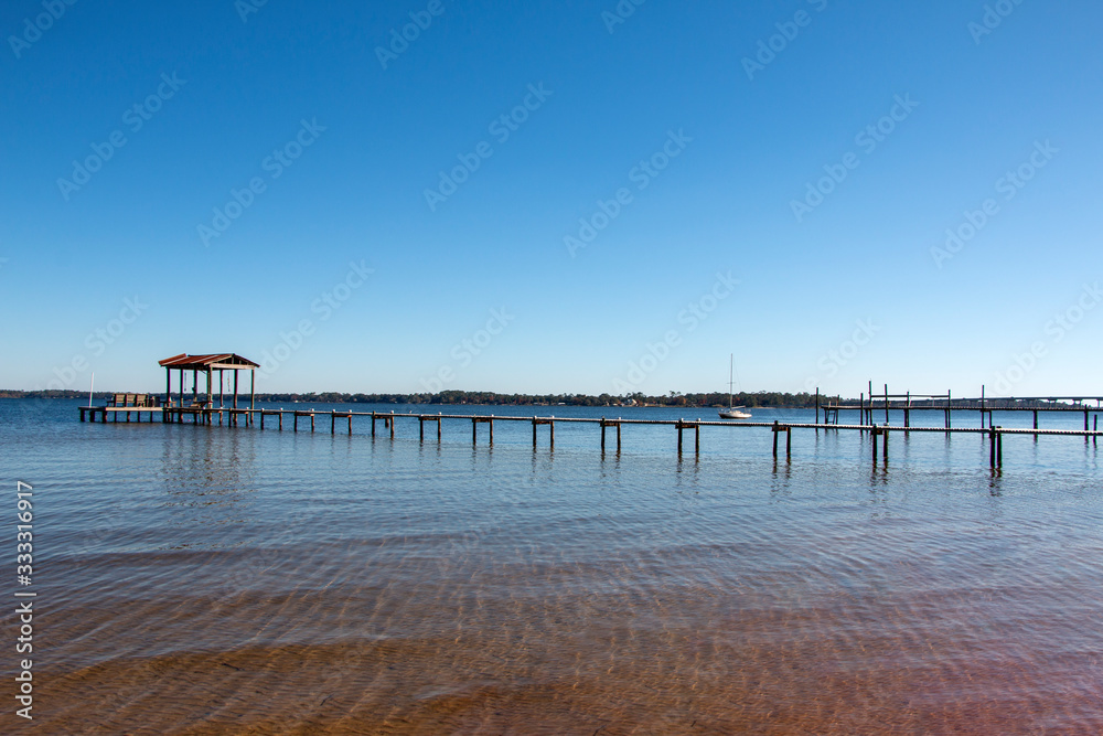 boat dock pier in perdido bay lillian alabama clear blue sky