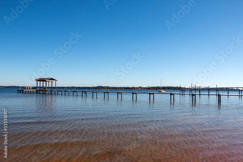 boat dock pier in perdido bay lillian alabama clear blue sky