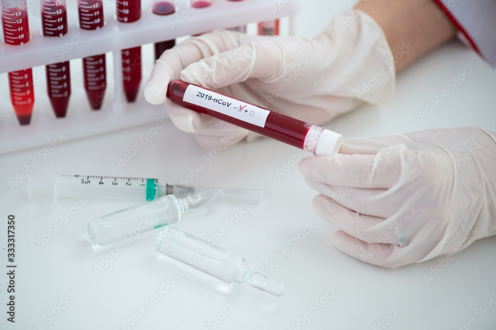 Test tubes with blood sample Covid-19 coronavirus. Vaccine and syringe injection It use for prevention, immunization and treatment from COVID Test tubes with blood sample Covid-19 coronavirus. Vaccine and syringe injection It use for prevention, immunization and treatment from COVID