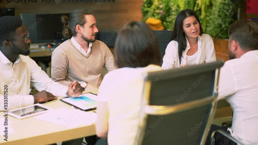 Professional coworkers working in team brainstorming on business plan for accountings, group of creative employees collaborating on project analyzing information during briefing in office
