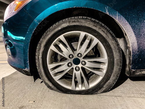 Flat Tire on a dirty candy metalic blue car