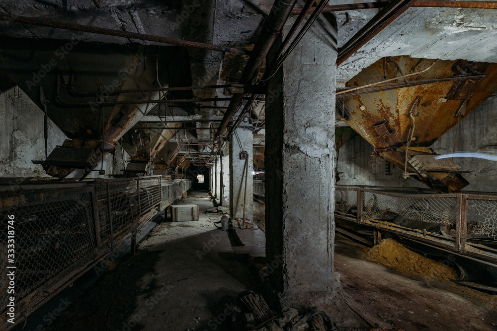 Abandoned cement and concrete factory. Old conveyor and rusty hoppers Abandoned cement and concrete factory. Old conveyor and rusty hoppers