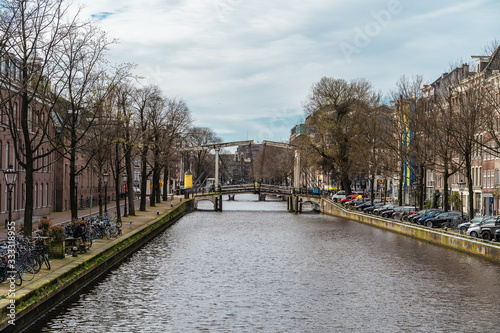 Famous Amsterdam canal and empty streets without people, Coronavirus Epidemic, city quarantine, COVID-19 outbreak. © DedMityay