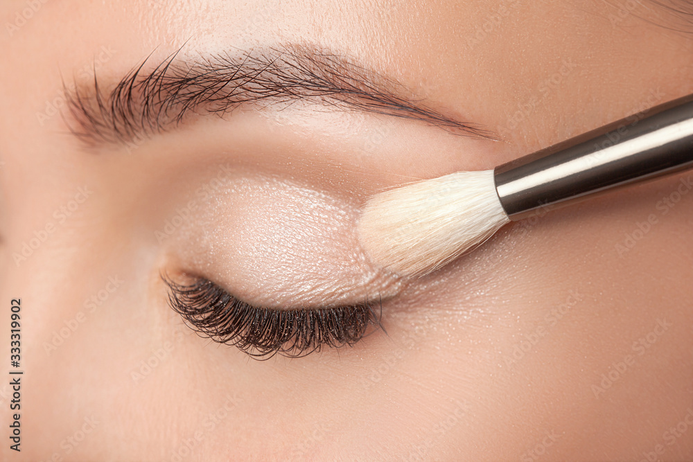 Portrait of a beautiful woman with long eyelashes, beautiful make-up, thick eyebrows and with clean skin in a beauty salon. Eyelash extensions. Makeup and cosmetology concept. Portrait of a beautiful woman with long eyelashes, beautiful make-up, thick eyebrows and with clean skin in a beauty salon. Eyelash extensions. Makeup and cosmetology concept.