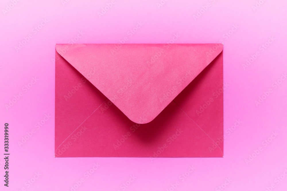 Closed pink envelope on pink background.