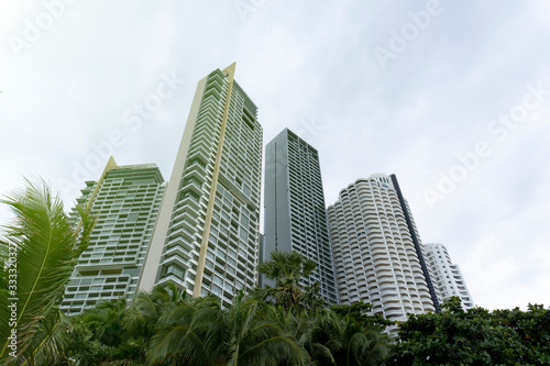 View at Pattaya city buildings from lower position, view up from down, from ground in summer day. © Maria Mikhaylichenko