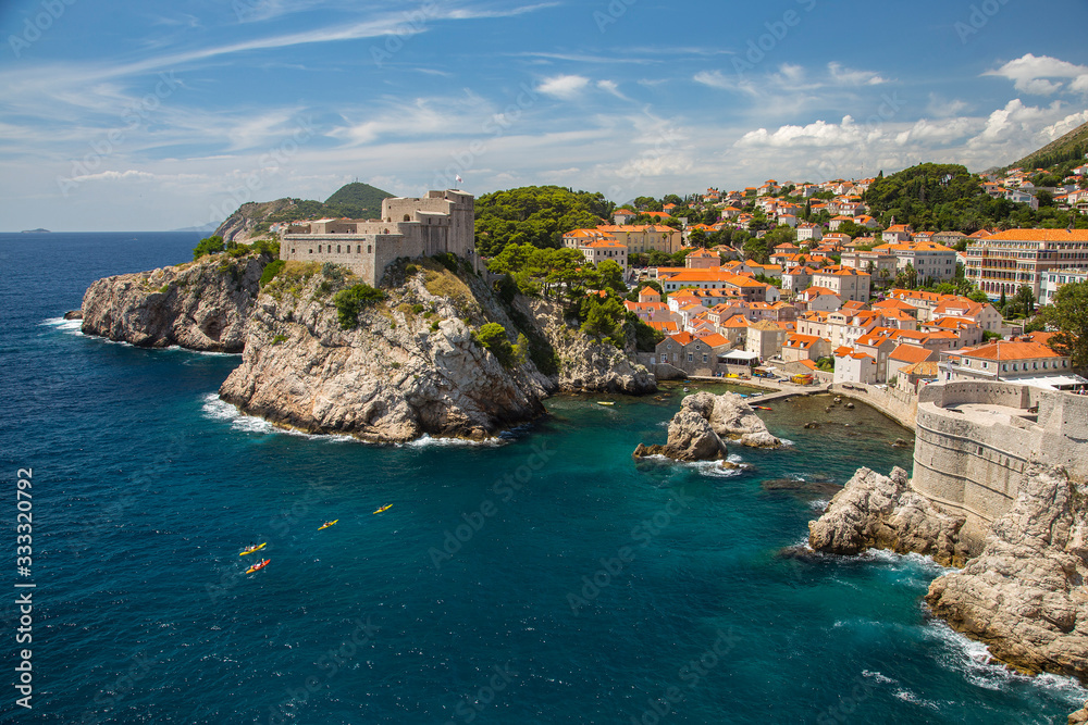 Kayakers on the coast with city walls of Dubrovnik, Croatia