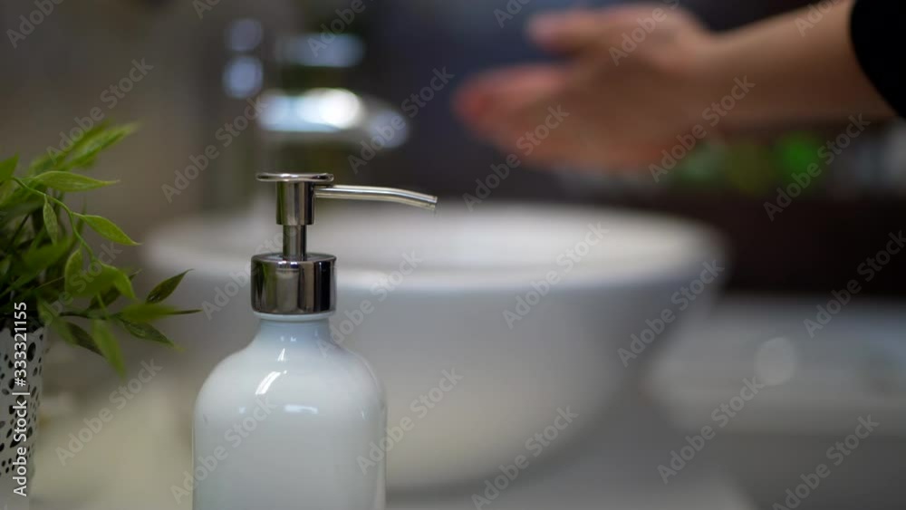 close up details of woman washing hands with soap and tap water. blurred background close up details of woman washing hands with soap and tap water. blurred background
