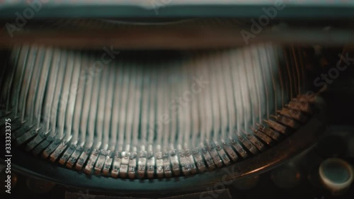 Vintage typewriter strikers. Camera truck right to left. Slow camera pan from right to left across vintage Underwood typewriter strikers. Isolated type writer. Screen writing novel writing. photo