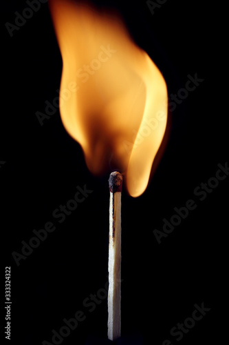 A burning safety match with black background © Sandor