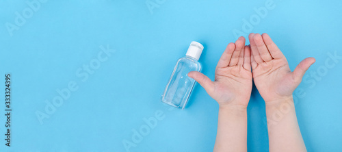 Hand cleaning gel. Pouring sanitising hand gel onto the child's hand. Banner panorama