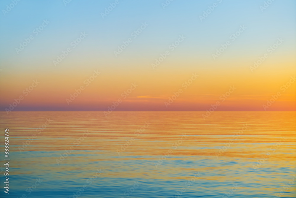 Fototapeta premium Beautiful orange sunset over Baltic sea. Nature background. Latvia. Copy space for text