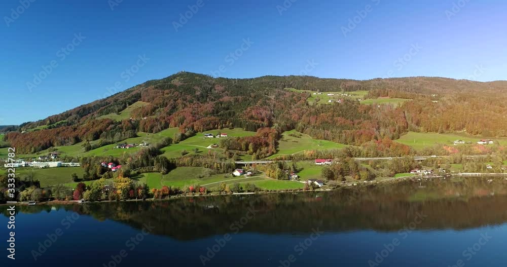 Green valley village on green hills at the bottom of mountains, near lake. Green valley village on green hills at the bottom of mountains, near lake.
