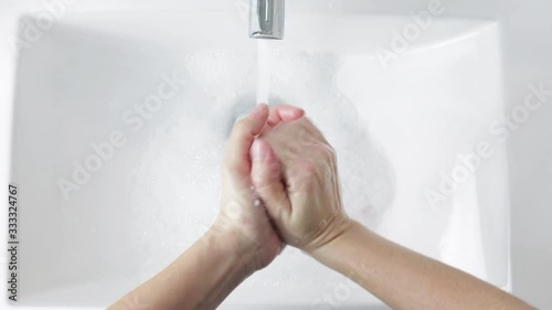 young person washing hands rubbing with soap for covid-19 epidemic prevention