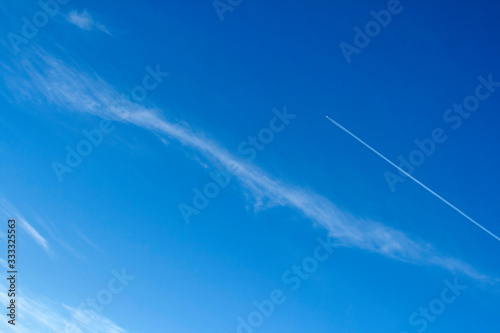 Vapor trails on the blue sky