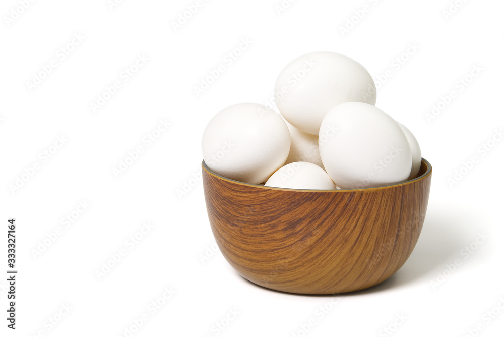 Eggs isolated in wooden bowl on white background Eggs isolated in wooden bowl on white background