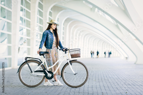 Young girl renting a bicycle to visit the city. Space for text