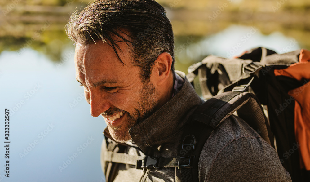 Fototapeta premium Camper smiling by the lake