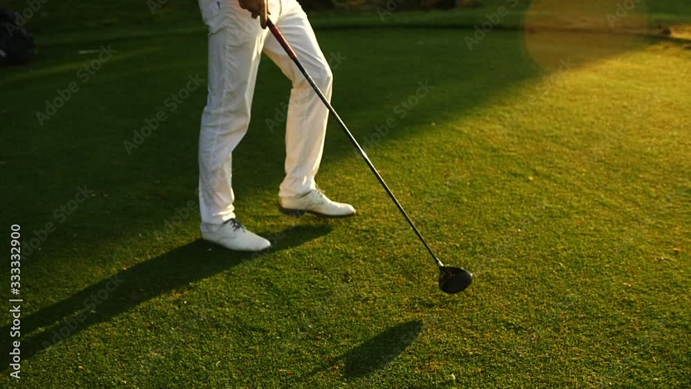 Golfer on the green during sunset