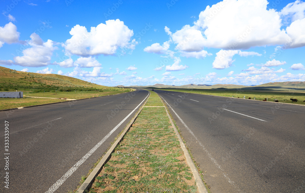 Empty highway, blue sky and white clouds landscape