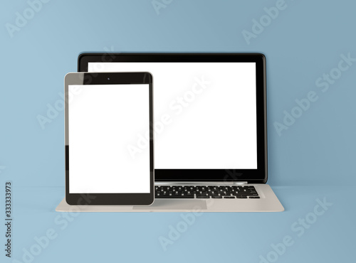 3D Illustration. Laptop and digital tablet with white screen.
