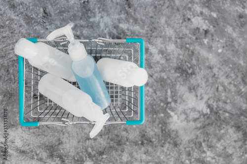 hygiene to slow the spread of germs and viruses, shopping basket fully of mixed sanitizers and cleaning supplies symbol of cleaning hands and surfaces to flatten the curve