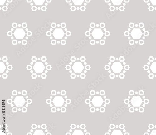 Subtle winter background with snowflakes. Vector abstract minimalist geometric seamless pattern with hexagonal figures. Delicate white and light gray texture. Simple design for decor, fabric, cloth