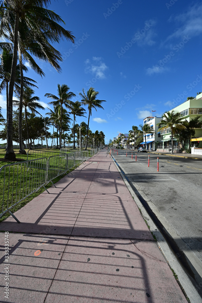 Miami Beach, Florida - March 21, 2020 - Ocean Drive appears empty as hotels, restaurants and beach ordered closed due to coronavirus pandemic. Miami Beach, Florida - March 21, 2020 - Ocean Drive appears empty as hotels, restaurants and beach ordered closed due to coronavirus pandemic.