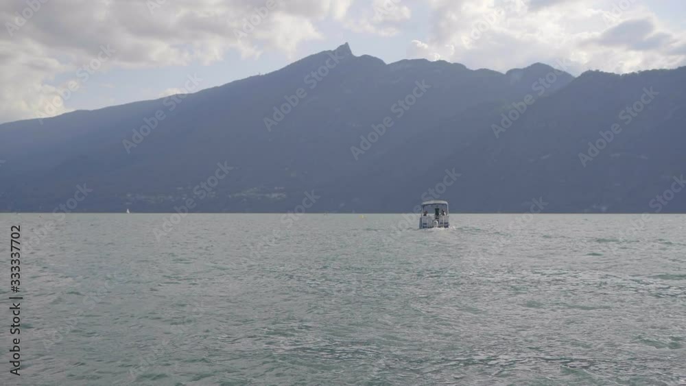 Boat leaving on a beautiful lake (Aix-les-bains, France) Boat leaving on a beautiful lake (Aix-les-bains, France)